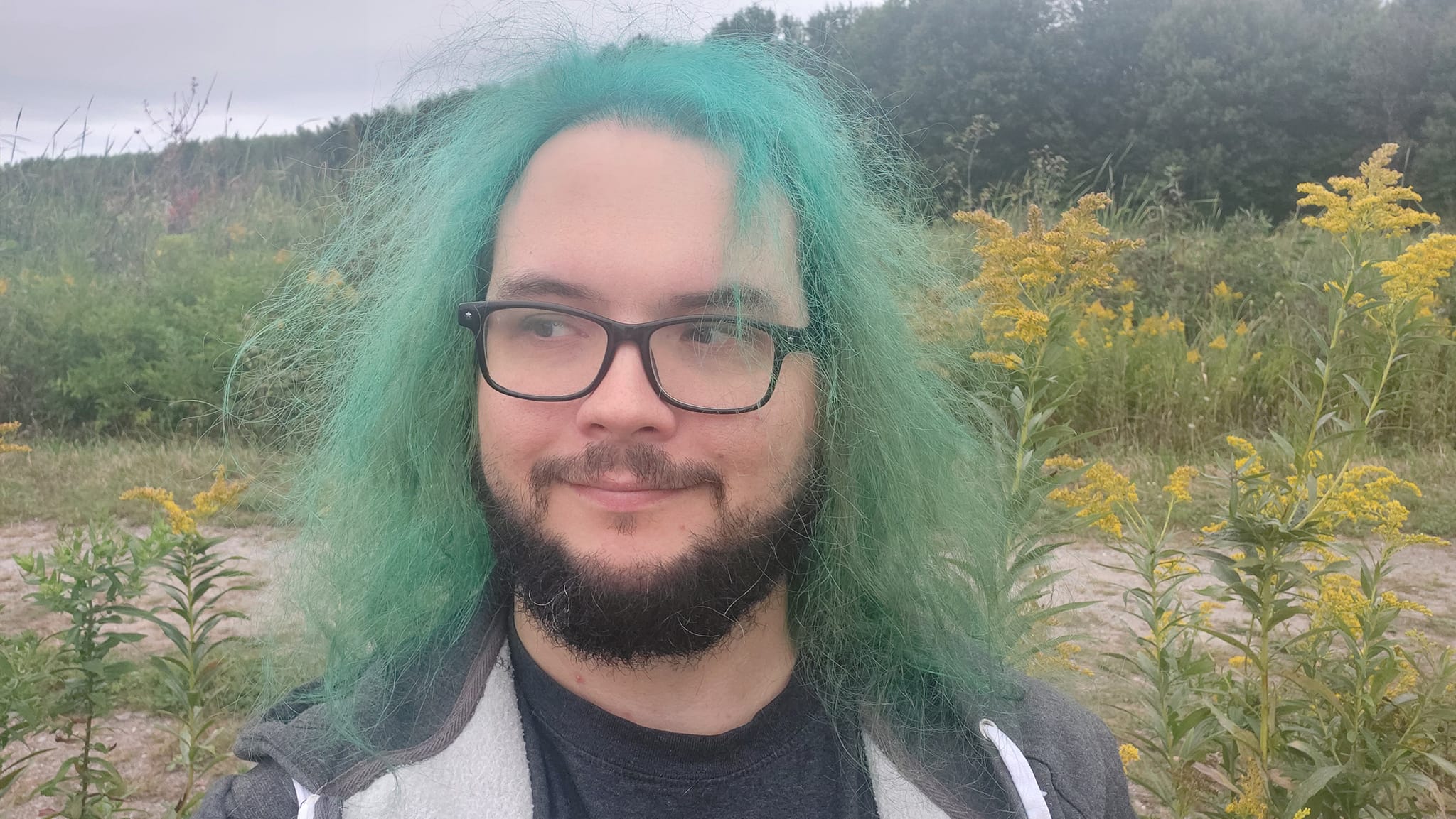 A man with green hair is visiting a freshwater marsh, photo 2